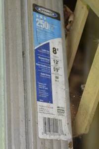 lot 9A image: 2 ladders one 8ft step- one telescoping