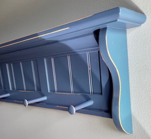 lot 57 image: Pottery Barn Kids Blue Shelf with Pegs