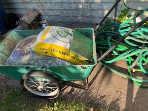 lot 205 image: Garden Hoses, Planting Mix, Wheel barrow & More