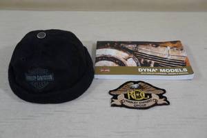 lot 128 image: Harley-Davidson Skull Cap, Dyna Model Manual, HOG Patch