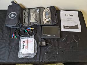 lot 124 image: Haier Portable 7 LCD TV, Carry Bag, and Accessories