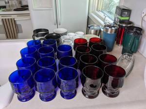lot 87 image: Assortment of Drinkware Mugs, Red Glass Cups, Blue Glass Cups, Tumblers, Tumbler Lids and More