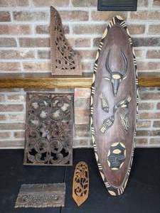 lot 239 image: Intricate Wood Carvings and African Mask-Style Decor (5 Pieces)