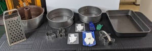 lot 554 image: 13-Piece Lot of Kitchen Ware Grater, 2 Spring-form Pans, Tube Pan, Rectangular Pan, Cookie Cutters and More