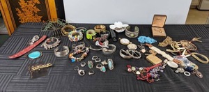 lot 486 image: As Assortment of Costume Jewelry that includes Watches, Hair Piece, Bracelets, Pins, Rings, and More