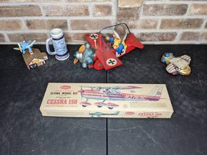 lot 521 image: Vintage Airplane Collection Swiss Musical Movement Musical Plane, Flying Cessna 150 Model Kit, Plane Ornament, Avon Plane Ceramic Mug and Musical House