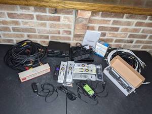 lot 508 image: Large Assortment of Electronics, Remotes and Cords Sears 40-Slide Tray, Cybex Channel Plus Switch View Noise Reduction Systems, Insignia Converter Box and More