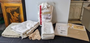 lot 559 image: Collection of Table Linens Lace Tablecloths, Cloth Napkins, Disposable Vanity Fair Tablecloths, New Gold Lame Tablecloth