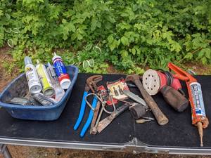 lot 727 image: Assortment of Tools Measuring Tape, Tool Shop Hand Sander, Caulk Gun, Hammer, Rotary Rasp & File and More