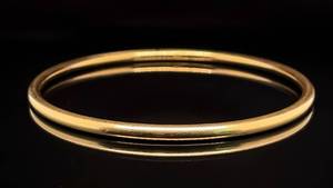 lot 87 image: Beautiful and Versatile Slim Round Stackable Vintage Bangle Bracelet in 14k Yellow Gold