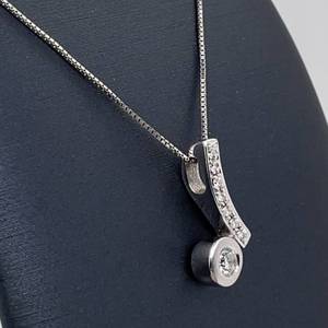 lot 102 image: Contemporary Diamond G Color Bezel Solitaire Journey Pendant in 18k White Gold