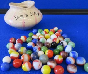 VINTAGE MARBLES IN A VINTAGE JAR.