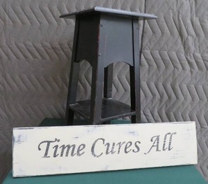 THE NAUGHTY CHAIR AND A WOODEN PLAQUE.
