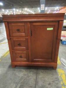 Home Decorators Collection. Naples 30 in. W 21.63 in. D Vanity Cabinet only in Warm Cinnamon with Left Hand Drawers - Cracked Bottom Board on backside.