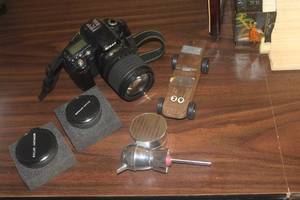 Lot of (5) Vintage Household - Nikon SLR Camera with Lens, (2) Merkury Optics Lens, Derby Car,