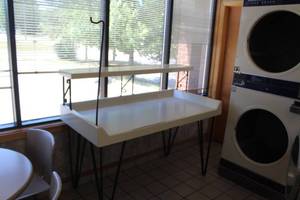 lot 124 image: Commercial Clothes Folding Table with (1) Hanger Rack