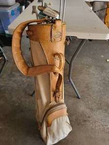 lot 17 image: Seven Gulf Clubs In A Divided Tan Colored Leather Golf Bag--A Wilson Driver