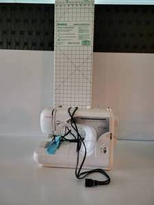 lot 62 image: Singer Sewing Machine & A Simplicity Sewing Essentials Pattern Cutting Board