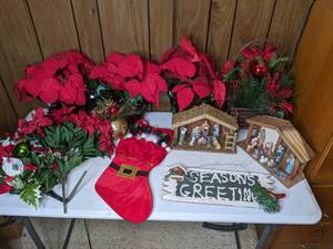 lot 317 image: Christmas Decor  Several Poinsettia Arrangements, Two Nativity Scenes, Stocking and Seasons Greeting Plaque