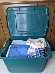 lot 307 image: Large Tub with Lid Filled with New and Used Bedding