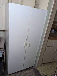 lot 233 image: Large White Cabinet Filled with Cleaning Supplies and Eureka Vacuum