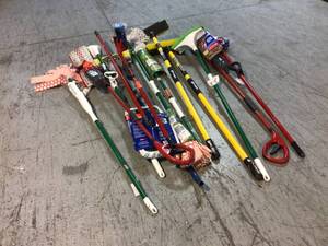 Assorted cleaning supplies mops and brooms