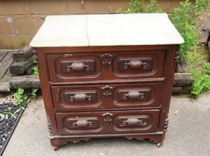 lot 1 image: Antique marble top commode with Ornate drawer pulls on wood casters AS IS marble top cracked in half