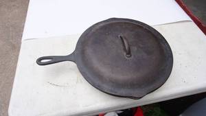 lot 15 image: LODGE cast iron covered frying pan 12 in#10 written under lid