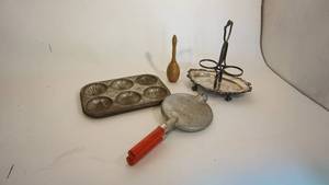 lot 202 image: Nordic ware KrumbKake iron, minute maid tin Baker, oilvinegar rack, wood rattle()