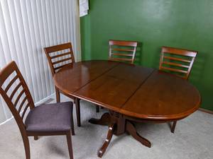 lot 34 image: Oval Wooden Dining Table with Extension Leaf Plus 4 Upholstered LadderbackDining Chairs
