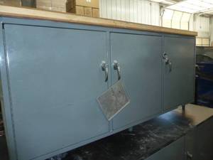 Warehouse storage cabinet with wood top measures 70x28x31 tall, 3 doors