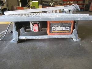 lot 12 image: RIDGID 120-Volt 7 in. Table Top Wet Tile Saw - USEDWORKS - Missing Water Pump - Sold AS Pictured.