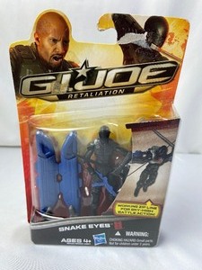 lot 179 image: G.I. Joe Retaliation - Snake Eyes (New in the Box) with 1950s Small Military Car