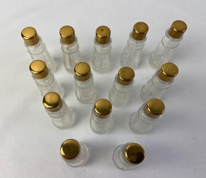 lot 316 image: Vintage Set of 14 Matching Tiny Perfume Bottles with Egyptian Motif