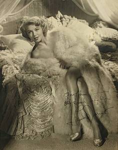 lot 167 image: Autographed LANA TURNER on Bed Pin-Up Photo- Framed