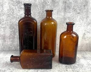 lot 515 image: 10 Name Brand Antique Amber Glass Bottles Lysol,Benetol, Rawleighs, Poison and more