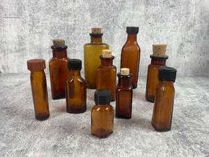 lot 513 image: 10 Vintage Amber Glass Bottles with Cork and Screw Tops