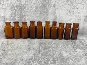 lot 509 image: Ten 2.5 Inch Vintage Amber Glass Bottles- Sharp & Dokke & More