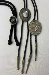 lot 529 image: Three Vintage Bolo Ties - Metalwork Western Motif in Purple Velvet Box