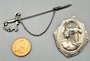 lot 475 image: Two Vintage Pins - A Large, Stunning Sterling Silver Cleopatra Profile in Bas-Relief and Delicate Sterling Sword