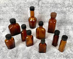 lot 409 image: 10 Amber Glass Antique Bottles with Screw Tops