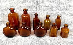 lot 410 image: 10 Vintage Amber Curved Bottles