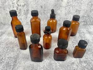 lot 470 image: 10 Antique Amber Glass Bottles w Black Caps
