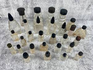 lot 490 image: 25 Vintage Clear Glass Bottle with Black Caps - 3 Old Monk Quality Supreme