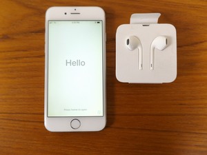 lot 36 image: Unlocked Apple iPhone Model A1586 and New Headphones