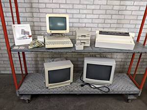 Apple IIc Computer Setup with Peripherals and Original Boxes