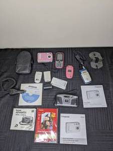 lot 231 image: Kodak Advantix 3600 ix Camera, Polaroid a520 Digital Camera, LG LX5350 Cell Phone, Car Chargers, Cell Phone Accessories, and more