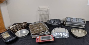 lot 130 image: Large Assortment of Kitchen Items and Bakeware Muffin Tins, Pumpkin Pan, Mini Loaf Pans, Bunt Pan and More