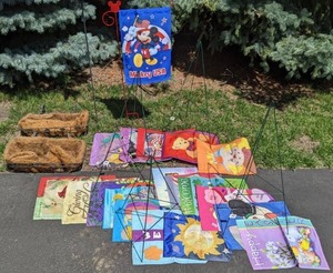 lot 209 image: Yard Decor Mickey Mouse Banner & Stand, 18 Banners, Tripod Stands, Mosaic Orb on Stand, 2 Coco Lined Planter Boxes