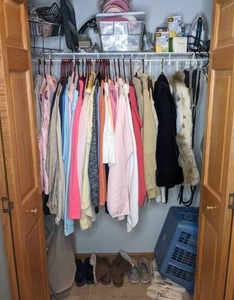 lot 191 image: The Entire Contents From a Womans Closet Sweatshirts, Coats, Fur Vest, Shoes, Iron, Ironing Board, Laundry Baskets and More